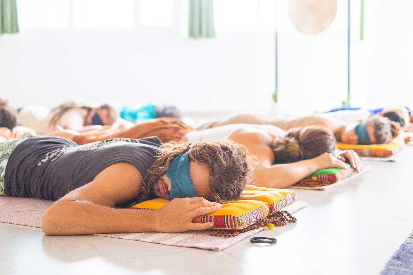 Group of people with eye masks in deep relaxation receiving sound healing at Tanmatraa Healing