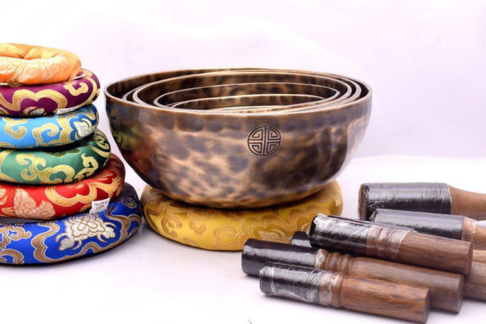 Healer holding a Tibetan singing bowl in sunlight